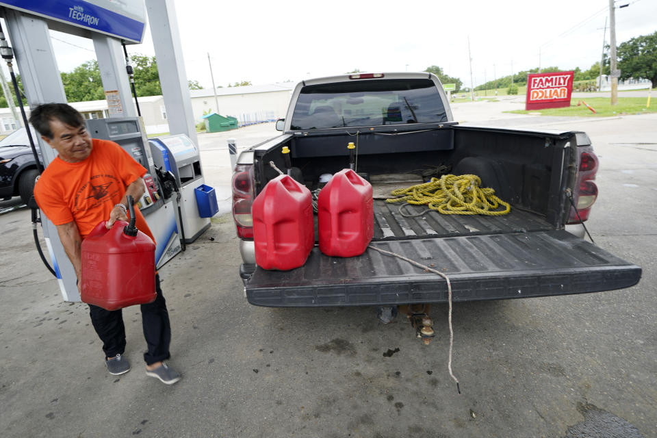 Robert Nguyen buys gas for his generator in Port Sulphur, La., Sunday, Aug. 23, 2020, in advance of Hurricane Marco, expected to make landfall on the Southern Louisiana coast. (AP Photo/Gerald Herbert)