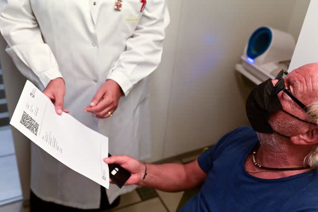 Zacco Cataldo, 70 years old receives a document proving his vaccination against the Covid-19, on August 5, 2021 at the Ambreck pharmacy, in Milan. - The Green Pass enters into force in Italy on August 6, 2021. (Photo by MIGUEL MEDINA / AFP) (Photo by MIGUEL MEDINA/AFP via Getty Images) (Photo: MIGUEL MEDINA via Getty Images)