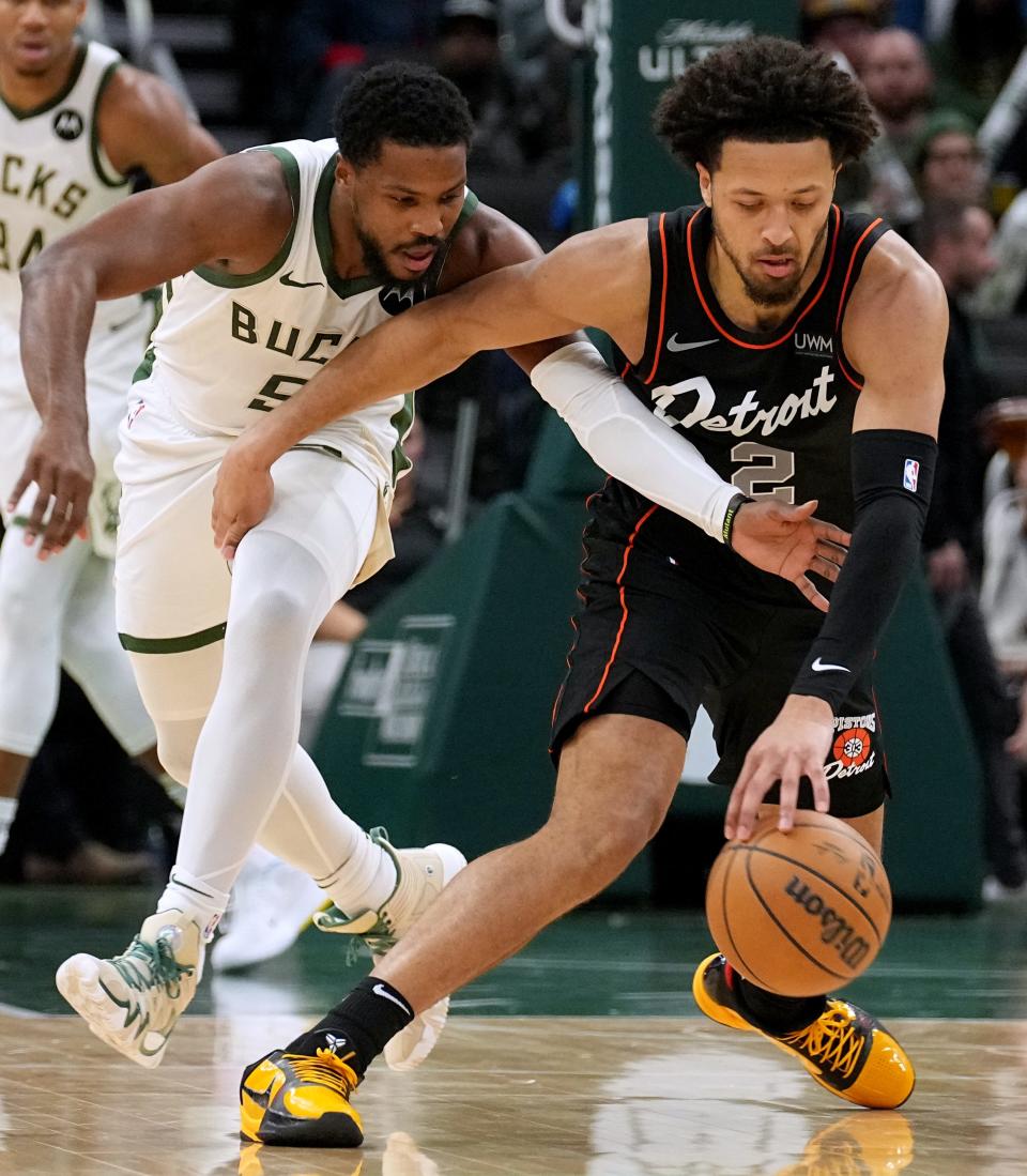 Bucks guard Malik Beasley, left, defends against Pistons guard Cade Cunningham during their game Wednesday at Fiserv Forum.