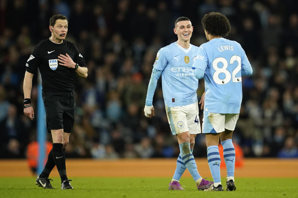 Manchester City's Phil Foden celebrates after scoring with teammate Rico Lewis during the English Premier League soccer match between Manchester City and Aston Villa at the Etihad Stadium in Manchester, England, Wednesday, April 3, 2024. (AP Photo/Dave Thompson)