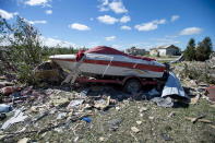 <p>A boat is surrounded by rubble in a neighbourhood destroyed by a tornado in Dunrobin, Ont., west of Ottawa, on Saturday, Sept. 22, 2018. The storm tore roofs off of homes, overturned cars and felled power lines in the Ottawa community of Dunrobin and in Gatineau, Que. (Photo from Justin Tang/The Canadian Press) </p>