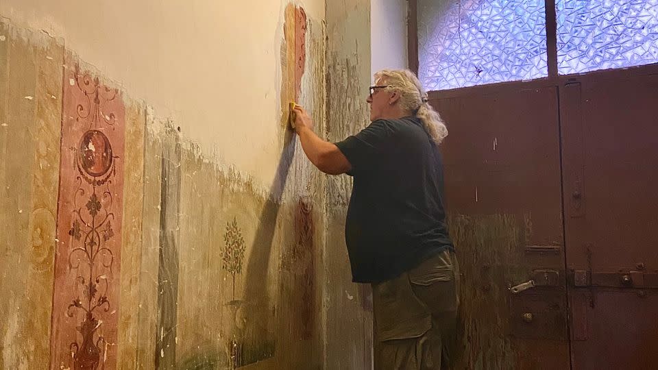 Jess and Kelly have been painstakingly removing the paint covering some hidden frescoes in the property. - Kelly Galloway