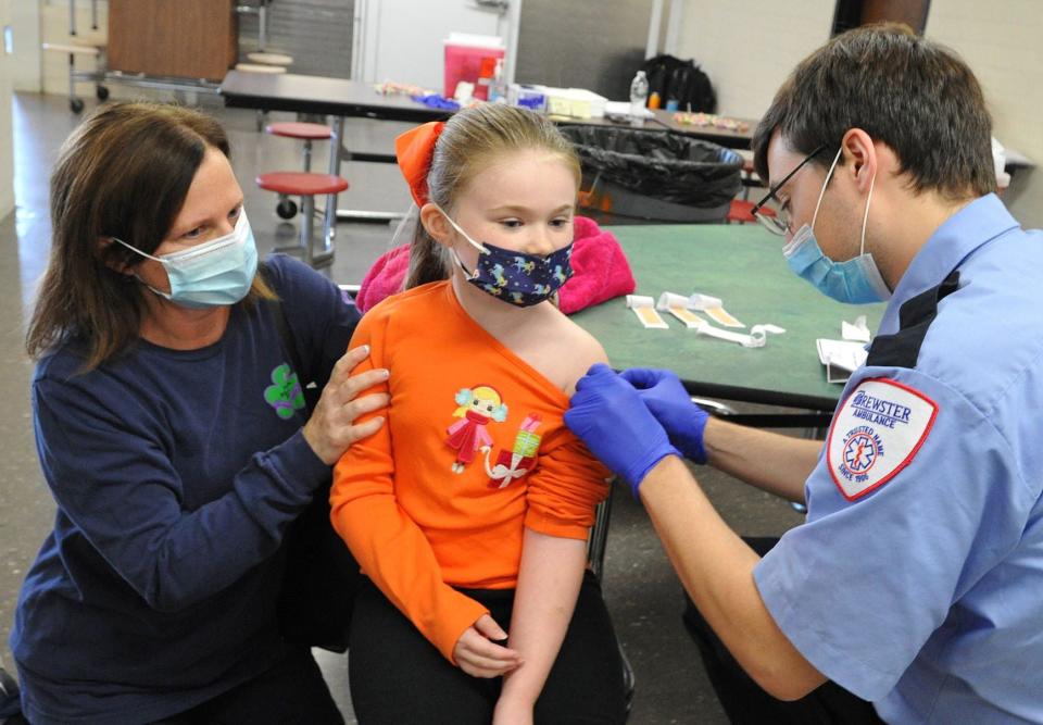 Megan Symonds, 7, of Weymouth receives her COVID-19 vaccine Saturday, Nov. 20, 2021.