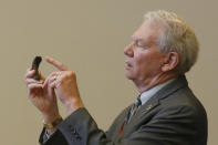 Butte County District Attorney Michael Ramsey gestures to the broken "C" hook, that investigators determined was the cause of the 2018 Camp Fire, during the criminal sentencing hearing in the trial of Pacific Gas & Electric Corp in Chico, Calif., Thursday, June 18, 2020. Pacific Gas & Electric on Thursday was fined $4 million for the deaths of 84 people killed in a nightmarish Northern California wildfire ignited by the its long-neglected electrical grid. The sentencing comes as the nation's largest utility prepares to end a 17-month bankruptcy proceeding triggered by the catastrophe. (AP Photo/Rich Pedroncelli, Pool)