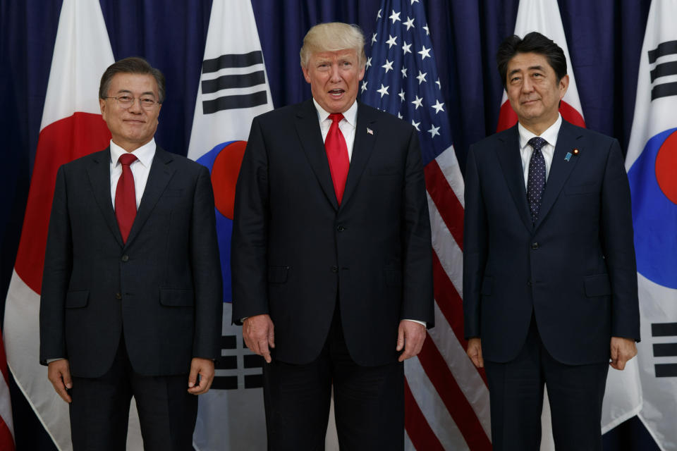 FILE - In this July 6, 2017, file photo, U.S. President Donald Trump, center, stands with Japanese Prime Minister Shinzo Abe, right, and South Korean President Moon Jae-in before the Northeast Asia Security dinner at the U.S. Consulate General Hamburg, in Hamburg. Trump and North Korean leader Kim Jong Un will likely be all smiles as they shake hands later this week in Hanoi for a meeting meant to put flesh on what many critics call their frustratingly vague first summit in Singapore. In addition to the two main players, China, South Korea and Japan also have deep interests in what Trump and Kim can hammer out in Vietnam. (AP Photo/Evan Vucci, File)