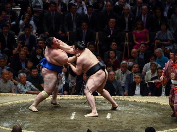 Japan’s Ryuden attempts to grab the throat of Aoiyama of Bulgaria during their clash (AFP/Getty Images)