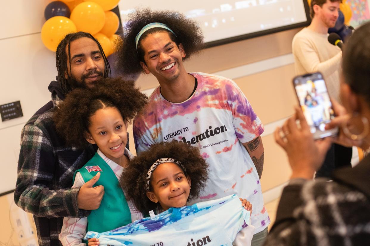 Mychal Threets smiles with some of his fans at an event in Philadelphia. He's used his social media platform to promote literacy, libraries and mental health awareness.