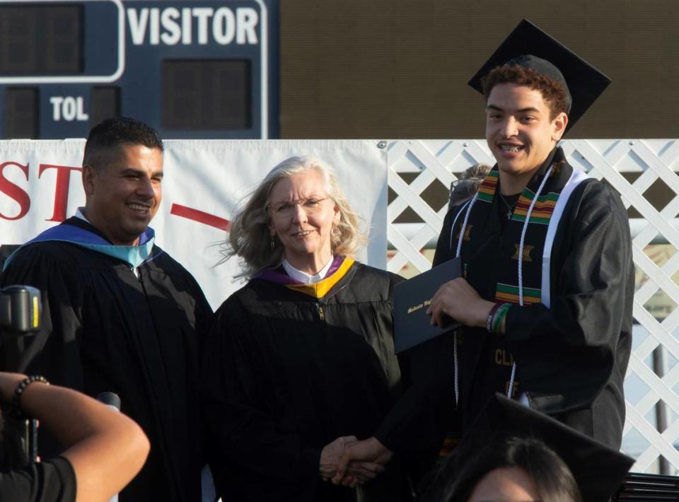 Jaden Johnson receives his diploma from school board member Cindy Marks during Modesto High’s graduation. Modesto High School had its senior class walk the stage for graduation Thursday, May 25, 2023 at Modesto Junior College.