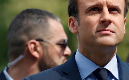 A body guard stands near Emmanuel Macron, head of the political movement En Marche !, or Onwards !, and candidate for the 2017 French presidential election, attends a ceremony at a monument in memory of mass killings of Armenians by Ottoman forces in 1915, in Paris, France, April 24, 2017. REUTERS/Christian Hartmann