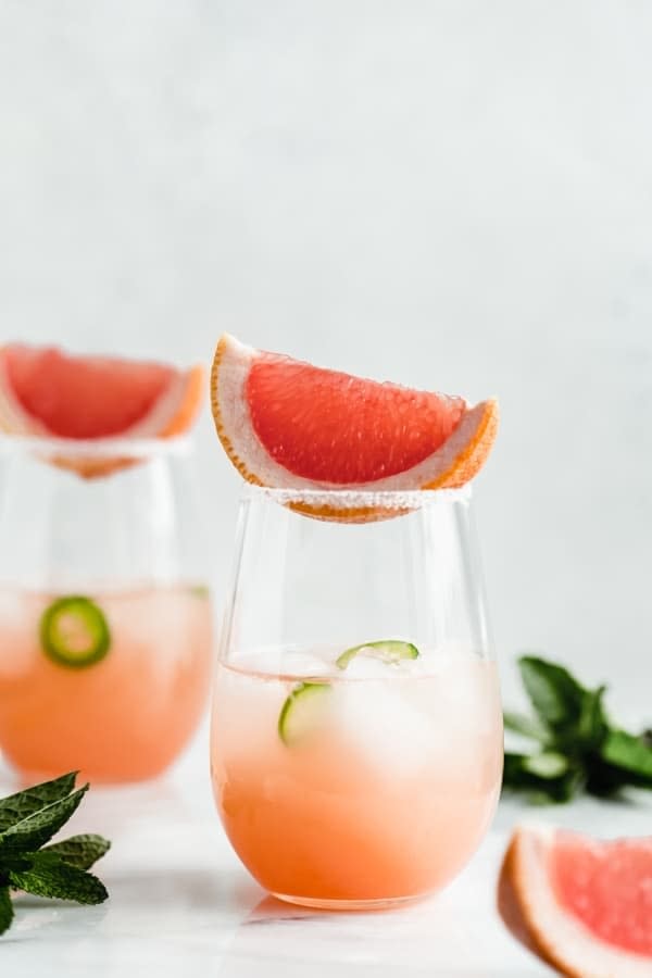 Two glasses of grapefruit cocktails.