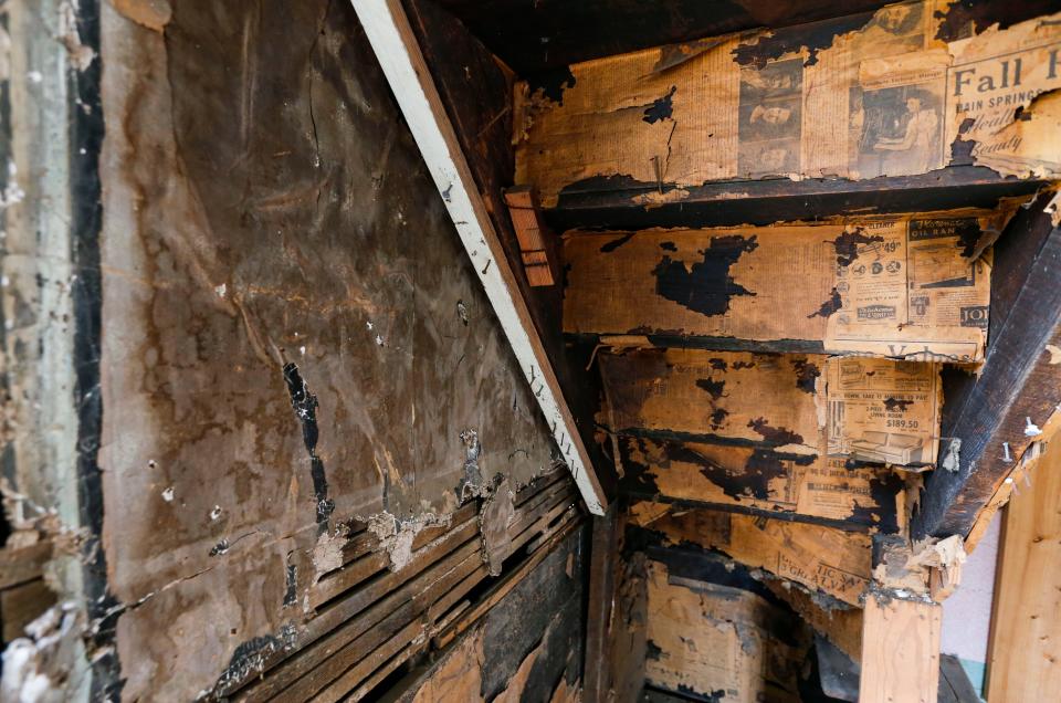 Old newspapers line the underside of a staircase inside the 1872 Neosho Colored School on Thursday, Nov. 9, 2023.