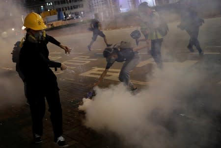 Anti-extradition bill protesters react after the police fired tear gas to disperse the demonstration at Sham Shui Po, in Hong Kong