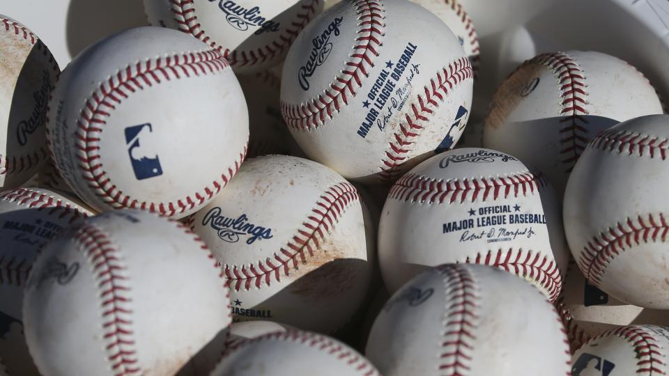 FILE - In this Feb. 14, 2020, file photo, baseballs sit in a bucket after they were used for fielding practice during spring training baseball workouts for pitchers and catchers at Cleveland Indians camp in Avondale, Ariz. Pitchers will be ejected and suspended for 10 games for using illegal foreign substances to doctor baseballs in a crackdown by Major League Baseball that will start June 21. The commissioner’s office, responding to record strikeouts and a league batting average at a more than half-century low, said Tuesday, June 15, 2021 that major and minor league umpires will start regular checks of all pitchers, even if opposing managers don’t request inspections. (AP Photo/Ross D. Franklin, File)