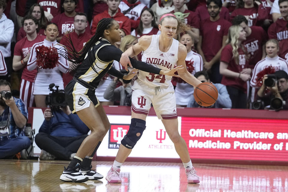 Indiana's Grace Berger (34) is fouled by Purdue's Jayla Smith (3) during the first half of an NCAA college basketball game, Sunday, Feb. 19, 2023, in Bloomington, Ind. (AP Photo/Darron Cummings)