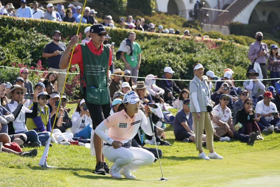 Jin Young Ko and her caddie, David Brooker, line up a shot on the 18th green during the final round of the LPGA's Palos Verdes Championship golf tournament on Sunday, May 1, 2022, in Palos Verdes Estates, Calif. (AP Photo/Ashley Landis)