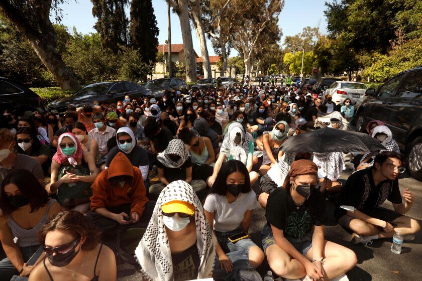 CLAREMONT, CA - APRIL 11, 2024 - Over 200 Pomona College students and students from the other Claremont Colleges, shut down a section of College Avenue to stage a sit-in in front of Alexander Hall to protest Pomona College to divest from Israel, Israel out of Gaza and over the recent arrest of 20 students last week at in Claremont on April 11, 2024. Students were arrested for trespassing last week during a sit-in inside Alexander Hall on the Pomona campus. (Genaro Molina/Los Angeles Times)