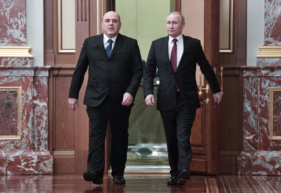 Russian President Vladimir Putin, right, and new Russian Prime Minister Mikhail Mishustin arrive to attend a new cabinet meeting in Moscow, Russia, Tuesday, Jan. 21, 2020. Putin formed his new Cabinet Tuesday, replacing many of its members but keeping his foreign, defense and finance ministers in place. (Alexei Nikolsky, Sputnik, Kremlin Pool Photo via AP)