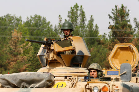 Turkish soldiers on an armoured vehicle are seen in Karkamis on the Turkish-Syrian border in the southeastern Gaziantep province, Turkey, August 25, 2016. REUTERS/Umit Bektas