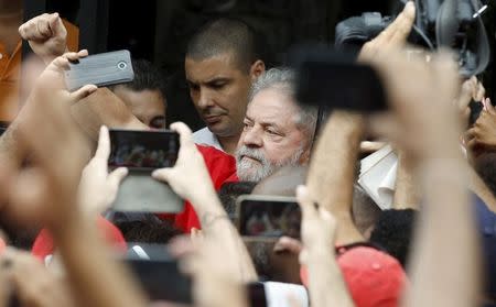 Former Brazilian President Luiz Inacio Lula da Silva gestures to a crowd in front of his home in Sao Bernardo do Campo, Brazil, March 13, 2016. REUTERS/Paulo Whitaker