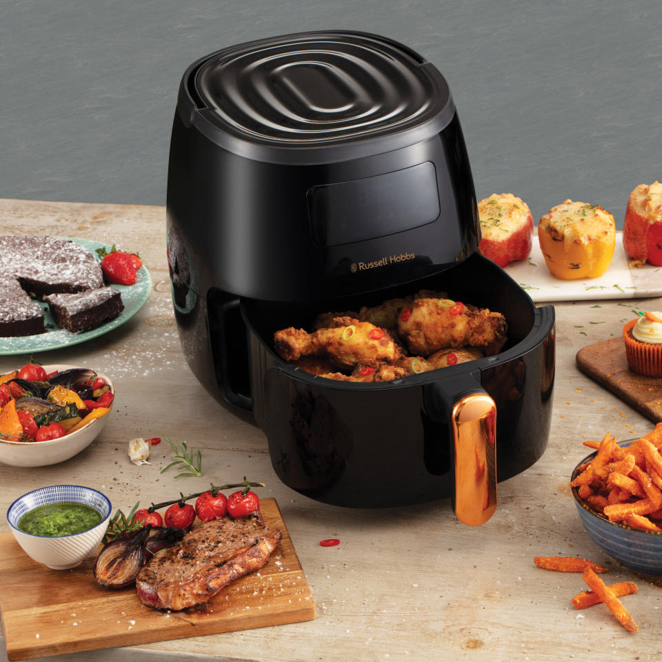 Russell Hobbs air fryer cooking food with food plates either side