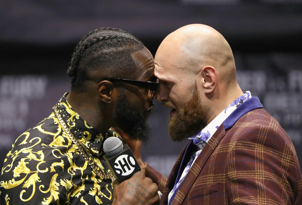 Deontay Wilder (L) and Tyson Fury butt heads onstage during a press conference to promote their upcoming Dec.1, 2018 fight in Los Angeles at The Novo by Microsoft on Oct. 3, 2018 in L.A. (Getty Images)