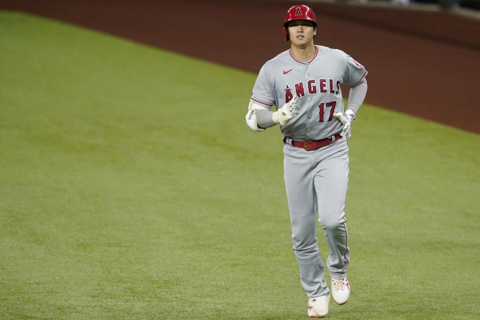 Los Angeles Angels' Shohei Ohtani jogs back to the dugout after grounding out during a baseball game against the Texas Rangers in Arlington, Texas, Wednesday, April 28, 2021. (AP Photo/Tony Gutierrez)