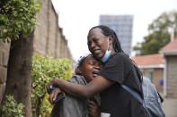 Edith Wanjiku, left, weeps after viewing the body of her son, who was allegedly shot by police during Tuesday's protest at the Nairobi funeral home, Kenya Wednesday, June 26, 2024. Thousands of protesters stormed and burned a section of Kenya's parliament Tuesday to protest tax proposals. Police responded with gunfire and several protesters were killed. (AP Photo/Brian Inganga)