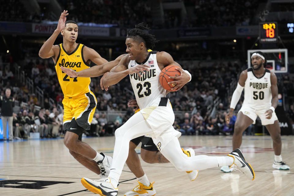 FILE - Purdue guard Jaden Ivey (23) drives to the basket next to Iowa forward Kris Murray (24) during the first half of an NCAA college basketball game at the Big Ten tournament March 13, 2022, in Indianapolis. Ivey is the headliner among point guard prospects in next week's NBA draft. (AP Photo/Darron Cummings, File)