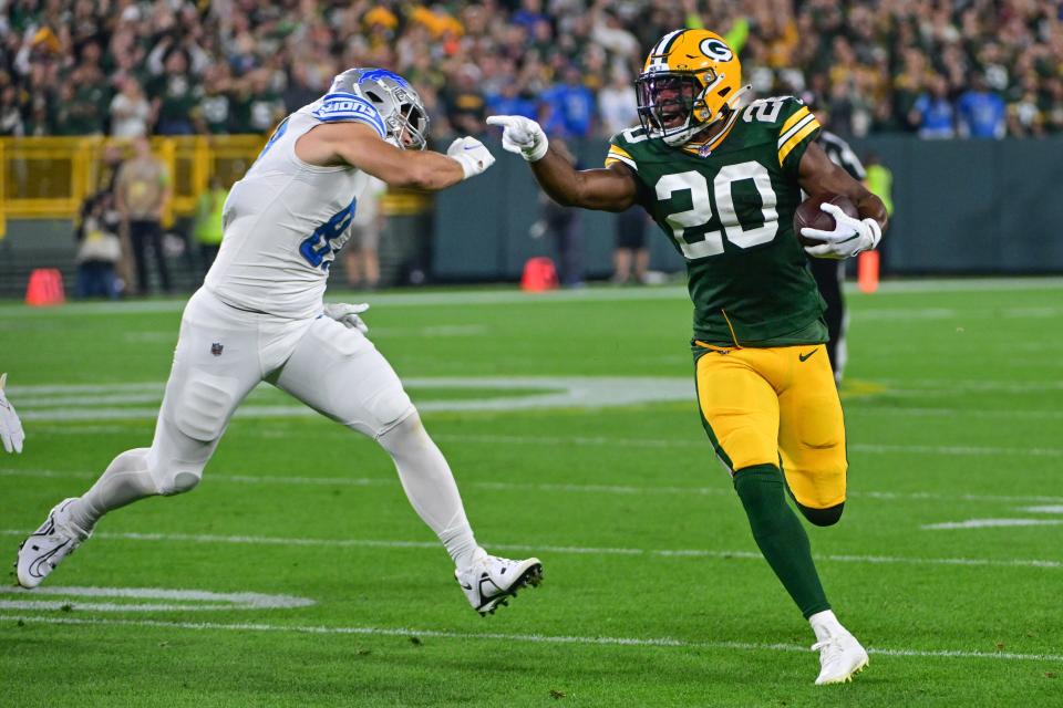 Green Bay Packers safety Rudy Ford (20) returns an interception in the first quarter against the Detroit Lions.