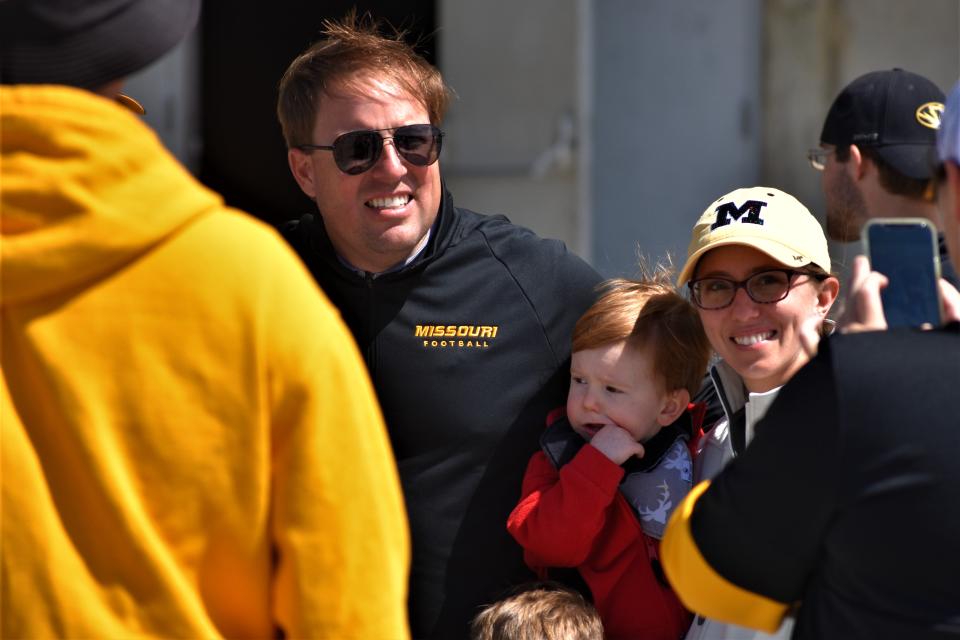 Missouri head football coach Eli Drinkwitz poses for a photo with fans during Missouri athletics' Come Home Tour stop Sunday outside the Hearnes Center.