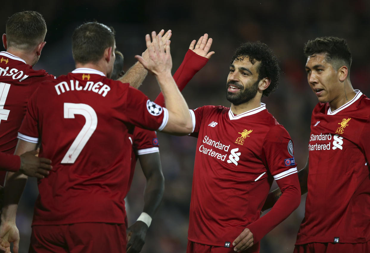 Liverpool’s Mohamed Salah, second from right, celebrates with teammates after their third goal against Roma in the Champions League semifinals first leg on Tuesday at Anfield. (Associated Press)
