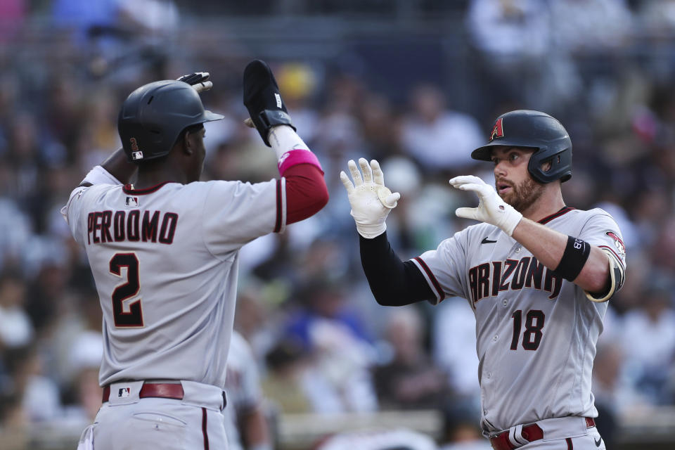 Arizona Diamondbacks' Carson Kelly, right, is congratulated by Geraldo Perdomo as he crosses home plate after hitting a two-run home run against the San Diego Padres during the fifth inning of a baseball game Saturday, July 16, 2022, in San Diego. (AP Photo/Derrick Tuskan)