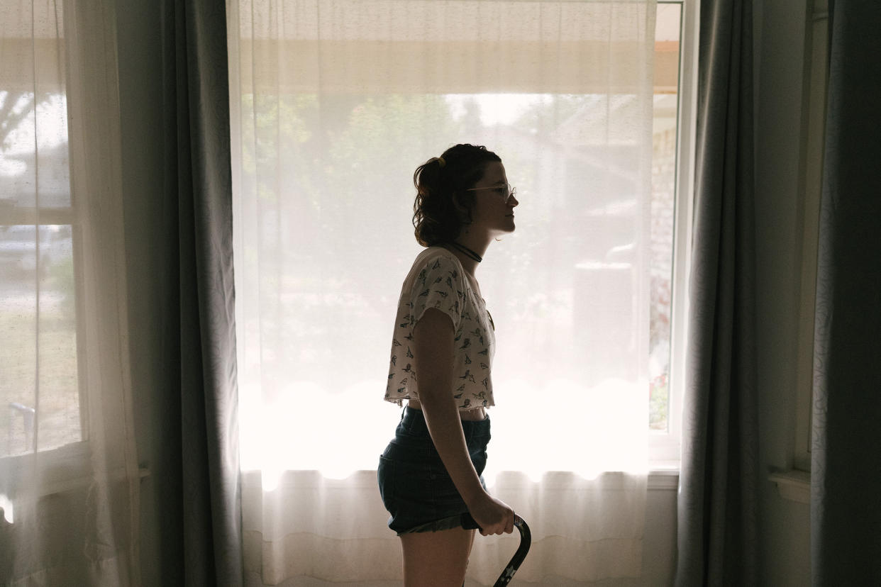 Flora Ellis in her living room in Norman, Okla., on July 19, 2022. Ellis has a connective-tissue disorder called Ehlers-Danlos syndrome, which prevents her body from properly making collagen.