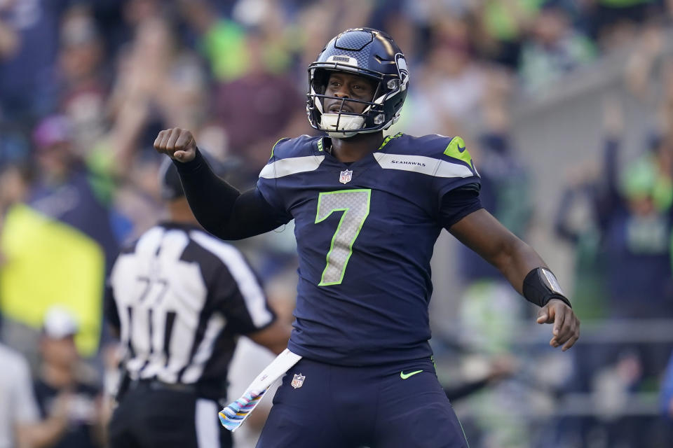 Seattle Seahawks quarterback Geno Smith (7) celebrates a touchdown run by running back Kenneth Walker III during the second half of an NFL football game against the Arizona Cardinals in Seattle, Sunday, Oct. 16, 2022. (AP Photo/Abbie Parr)