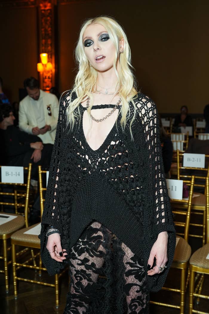 Taylor Momsen in a black, crochet dress with sheer, lace pants at a formal event