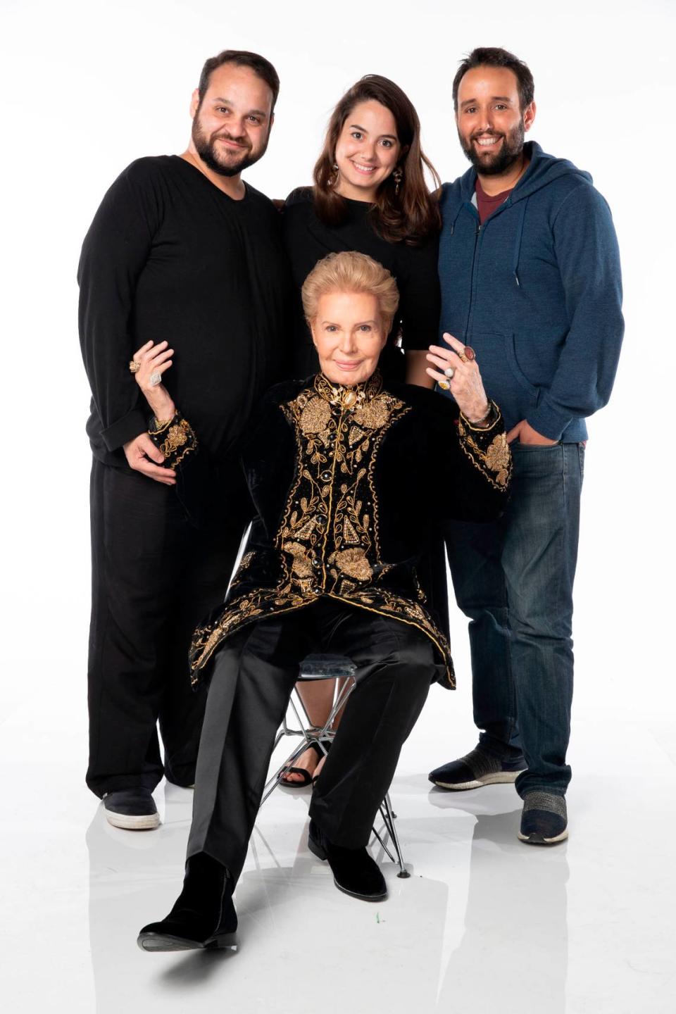 From left, co-directors Kareem Tabsch, Cristina Costantini and producer Alex Fumero stand around Walter Mercado in a publicity still for ‘Mucho, mucho amor.’