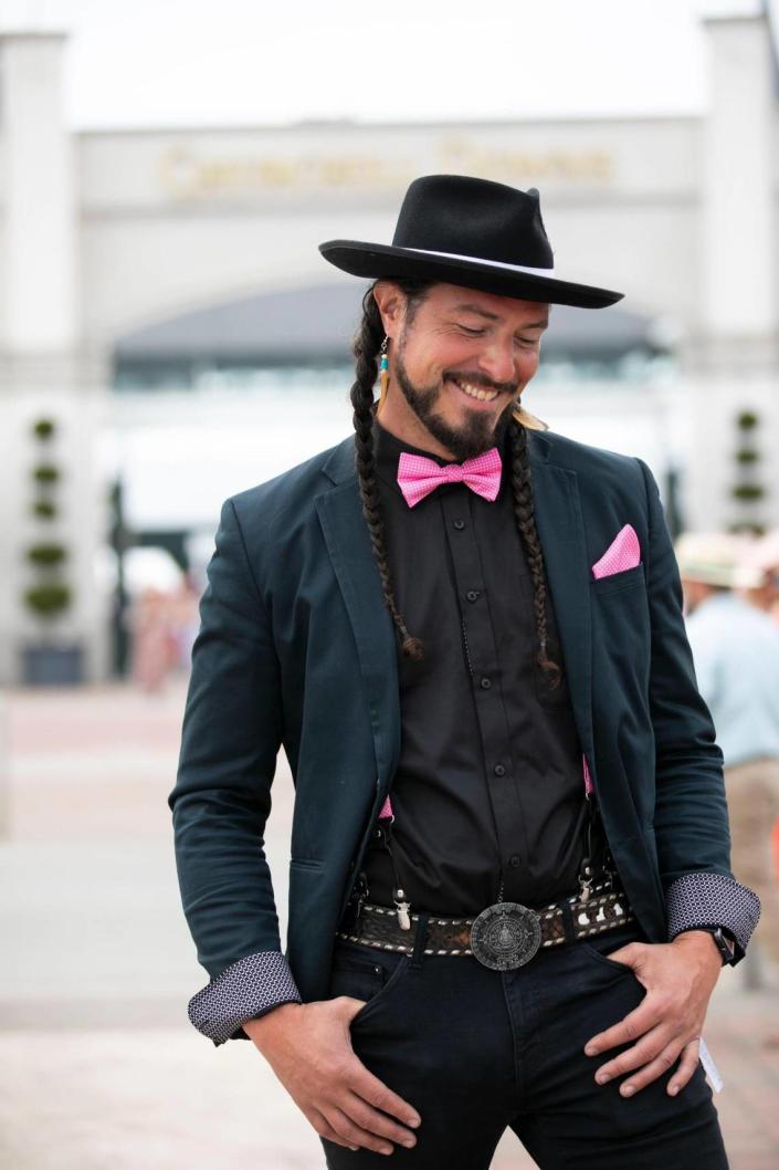 A participant wears pink accessories to accent his all-black look during the 149th running of the Kentucky Derby at Churchill Downs in Louisville, Ky., Saturday, May 6, 2023.  Amy Wallot