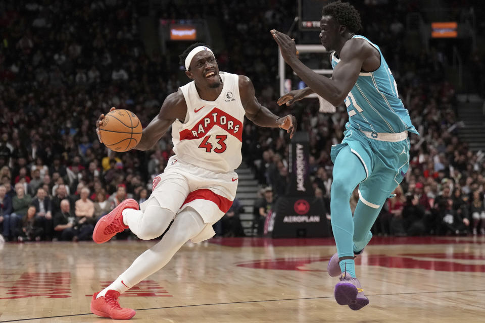 Toronto Raptors forward Pascal Siakam (43) drives to the net as Charlotte Hornets forward JT Thor (21) follows during second-half NBA basketball game action in Toronto, Monday, Dec. 18, 2023. (Nathan Denette/The Canadian Press via AP)