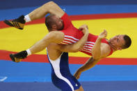 Marek Svec (red) of the Czech Republic is thrown by Aslanbek Khustov (blue) of the Russian Federation in the Men's Greco-Roman 96kg semi final bout at the China Agriculture University Gymnasium during Day 6 of the Beijing 2008 Olympic Games on August 14, 2008 in Beijing, China. (Ezra Shaw/Getty Images)