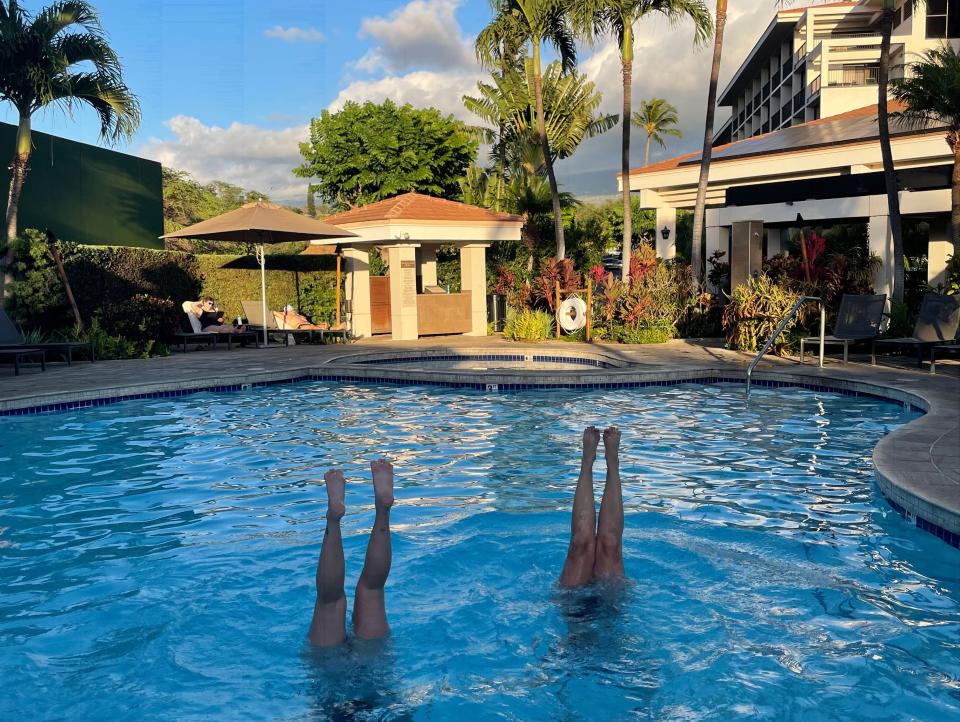 two people doing handstands in pool, maui, hawaii