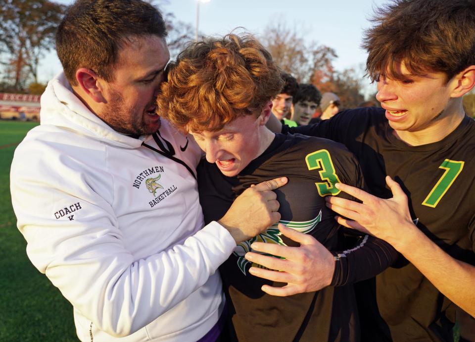 North Smithfield's Luke Letizia gets a hug from coach Eric Korytkowski (left) and teammate Joshua Neves (right) as the trio celebrated the Northmen's 4-2 win over Coventry in the RIIL Boys Soccer Division II Championship Saturday at Rhode Island College.