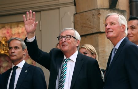 EC President Juncker waves as he arrives with EU chief Brexit negotiator Barnier in Luxembourg