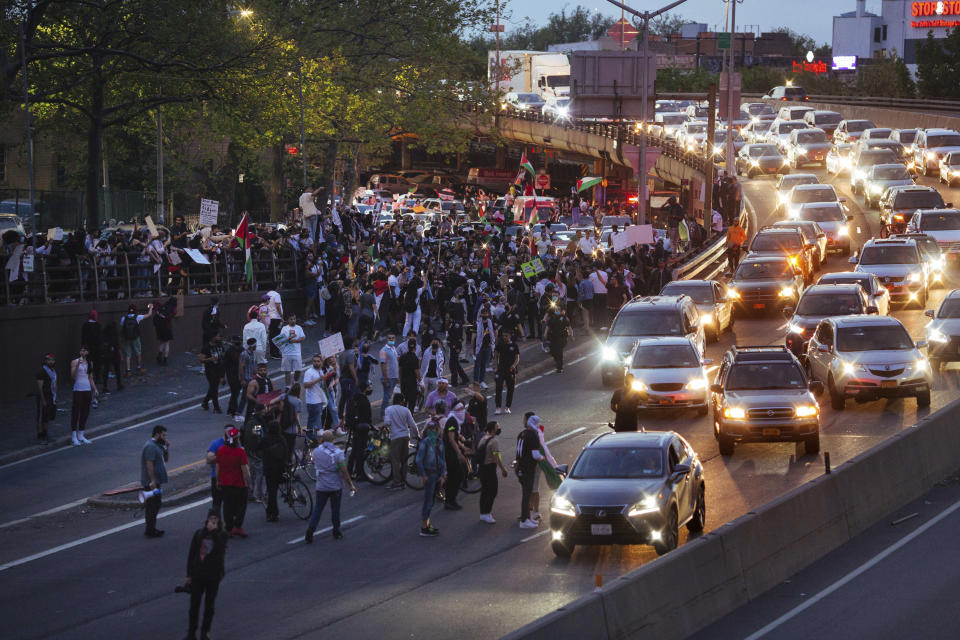Activists supporting Palestine block traffic on Interstate 278 Saturday, May 15, 2021, in New York. The rally supports Palestine in the ongoing conflict between Israel and Palestine on the day Israeli airstrikes leveled several buildings in the Gaza strip. (AP Photo/Kevin Hagen)