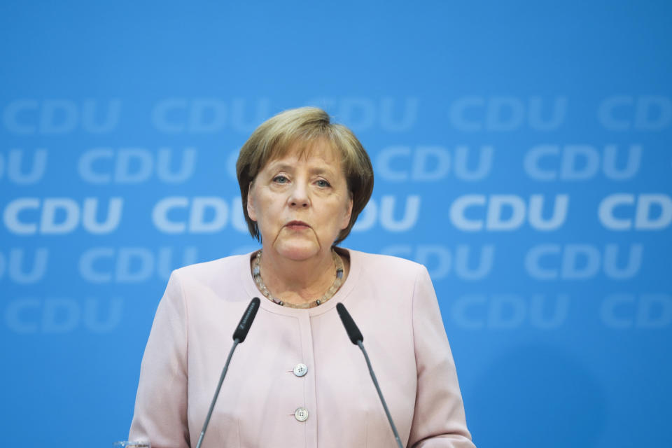 German Chancellor Angela Merkel speaks to media prior to a special closed meeting of her Christian Democratic Union at the party's headquarters in Berlin, Germany, Sunday, June 2, 2019. (AP Photo/Markus Schreiber)