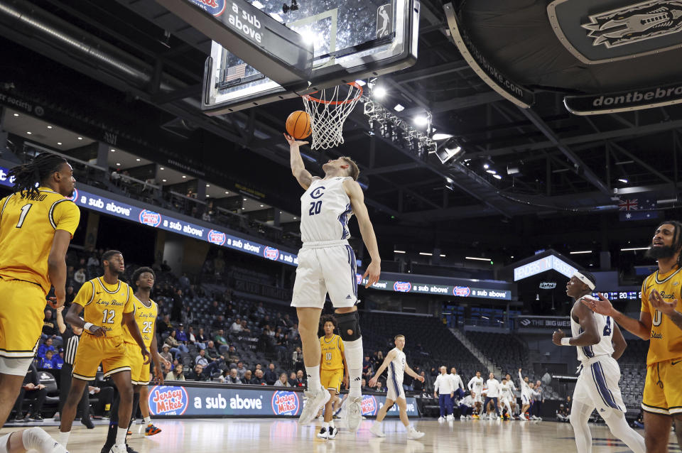 UC Davis forward Niko Rocak (20) goes up for a shot during the first half of an NCAA college basketball game against Long Beach State in the championship of the Big West Conference men's tournament Saturday, March 16, 2024, in Henderson, Nev. (AP Photo/Ronda Churchill)