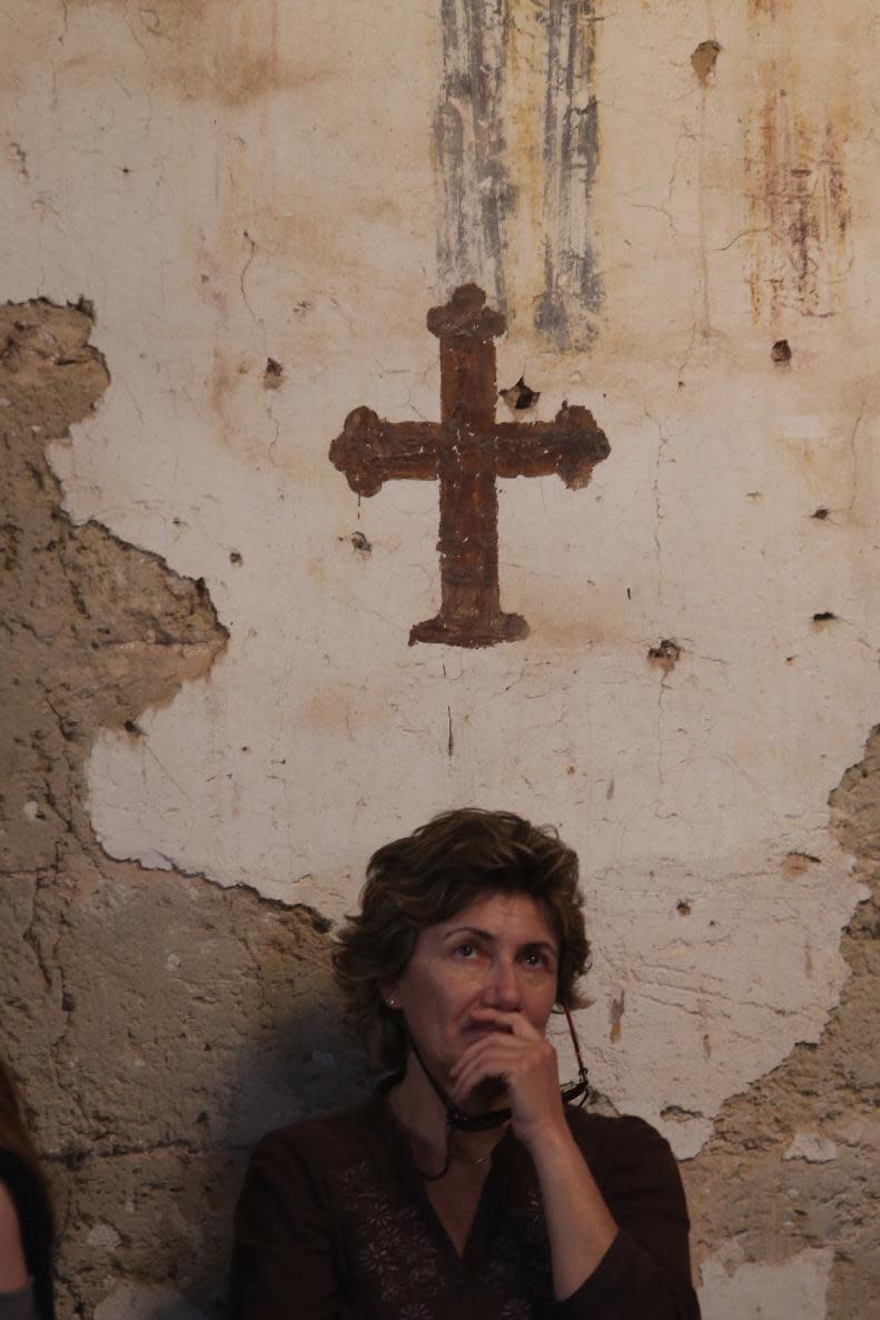 A Greek Orthodox Christian worshiper attends a Good Friday service at the church of Ayios Georgios Exorinos in Famagusta, in Cyprus’ breakaway Turkish Cypriot north on Friday, April 18, 2014. It’s the first time in nearly 60 years that such a service during Christianity’s holiest week is being held at this 14th century church. Although the island’s conflict has never been about religion, the service is seen as an example of how faith can help mend the island’s ethnic division. (AP Photo/Philippos Christou)