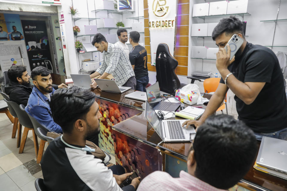 Customers buying computers and other digital accessories at a computer market in Dhaka, Bangladesh, Jan. 1, 2024. For decades, political battles in Bangladesh have been fought on the streets, often with violence, by parties led by two powerful women. But there are signs of a generational change as the country of 169 million heads into another general election Sunday. A burgeoning technology industry, lively e-commerce and growing public digital infrastructure are helping one of South Asia’s fastest growing economies capitalize on a tech-savvy workforce which is demanding change from politicians. (AP Photo/Mahmud Hossain Opu)