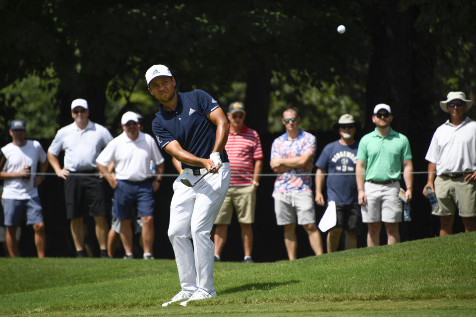 Xander Schauffele hits to the seventh green during the second round of the Tour Championship golf tournament Friday, Aug. 23, 2019, in Atlanta. (AP Photo/John Amis)