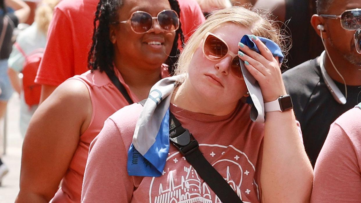 Woman wipes away sweat in Orlando