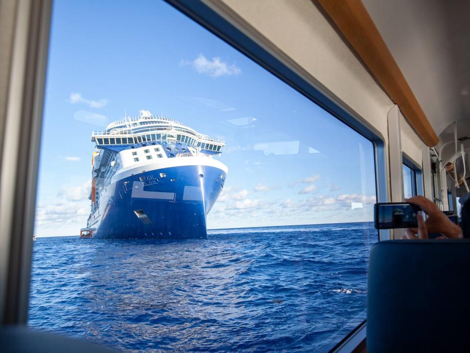 the Celebrity Apex cruise ship at sea as photographed through the window of a tender